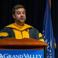 faculty talking on stage